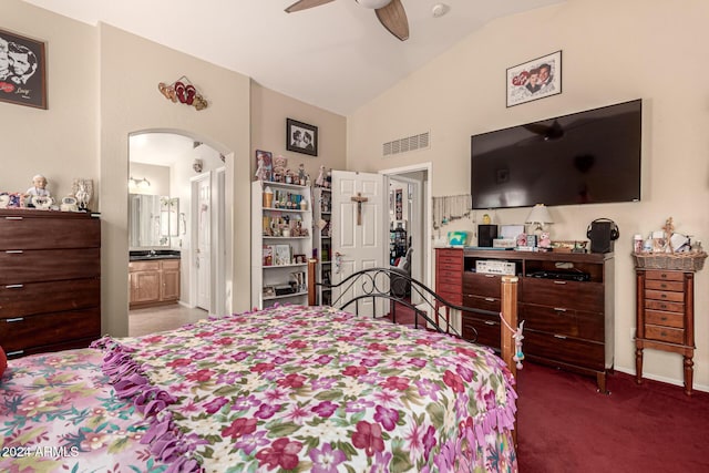 carpeted bedroom featuring ceiling fan, lofted ceiling, and ensuite bath