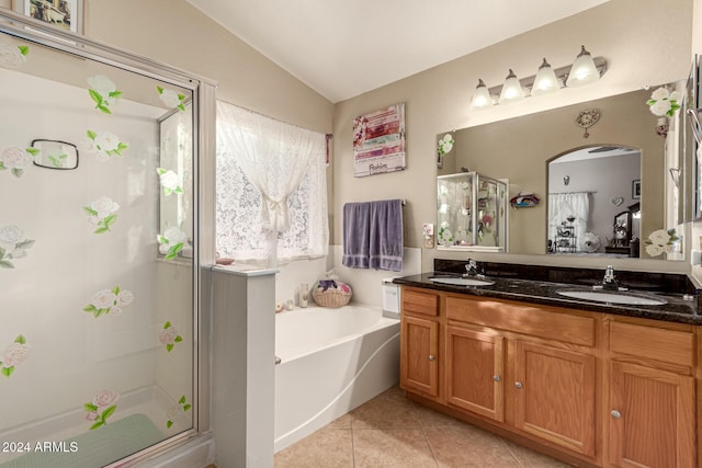 bathroom featuring tile patterned flooring, vanity, independent shower and bath, and lofted ceiling