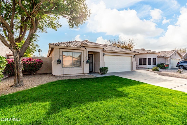 mediterranean / spanish-style home with a front lawn and a garage