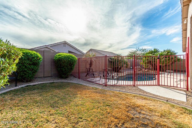 view of yard with a fenced in pool and a patio