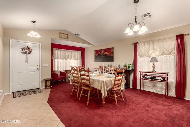 tiled dining space with a chandelier and vaulted ceiling