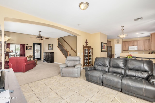 33335 N Slate Creek Dr, San Tan Valley, AZ 85143 - living area with ceiling fan, arched walkways, light carpet, light tile patterned flooring, and stairs