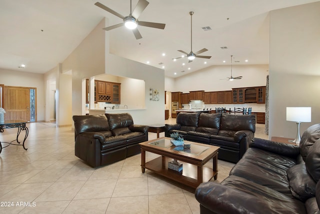 living room with high vaulted ceiling, ceiling fan, and light tile flooring