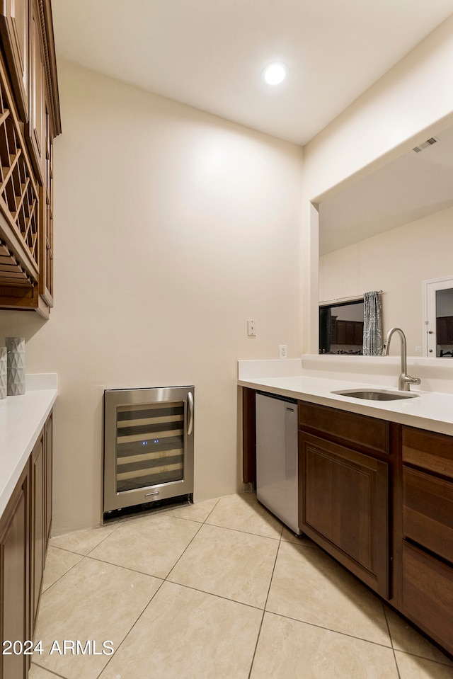 bathroom featuring sink, tile floors, and beverage cooler