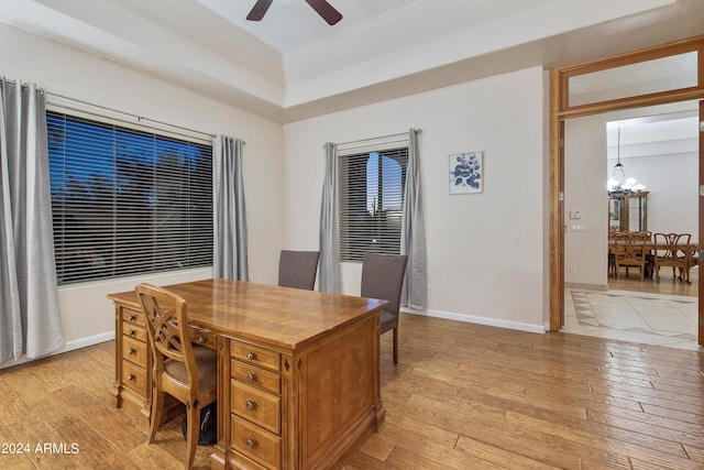 dining area with ceiling fan with notable chandelier and light wood-type flooring