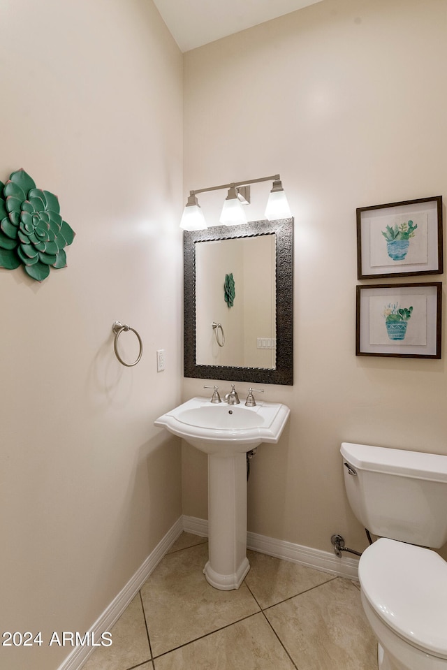 bathroom with toilet and tile flooring