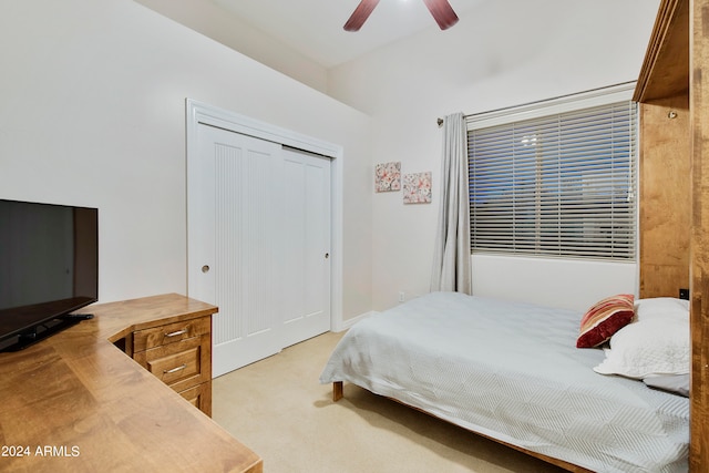 carpeted bedroom with a closet and ceiling fan