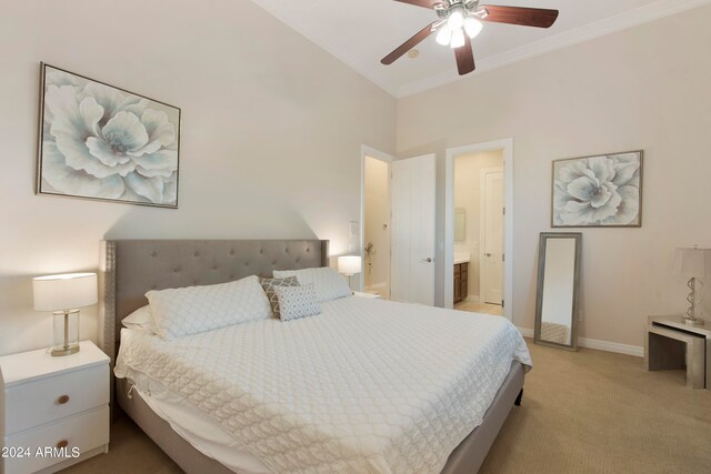 carpeted bedroom featuring ceiling fan and ensuite bathroom