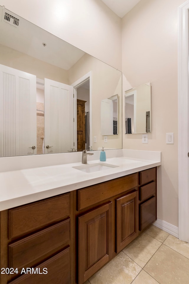 bathroom with tile flooring and vanity