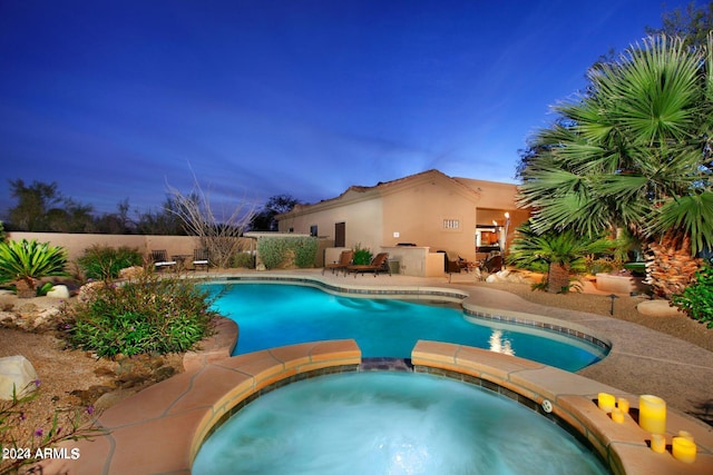 view of pool featuring a patio area and an in ground hot tub