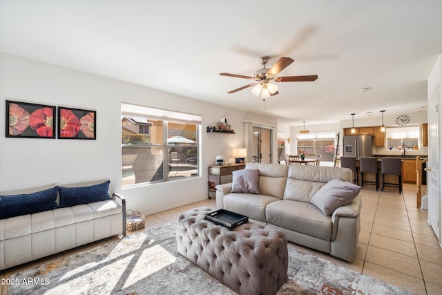 living area featuring light tile patterned flooring and a ceiling fan