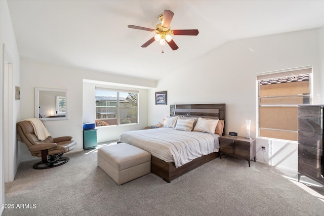 carpeted bedroom featuring vaulted ceiling and a ceiling fan