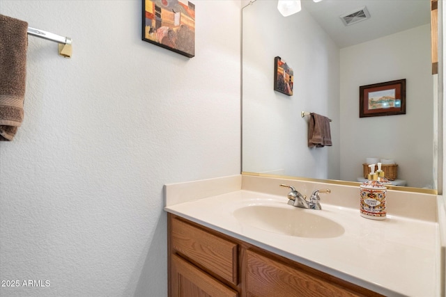 bathroom with visible vents and vanity