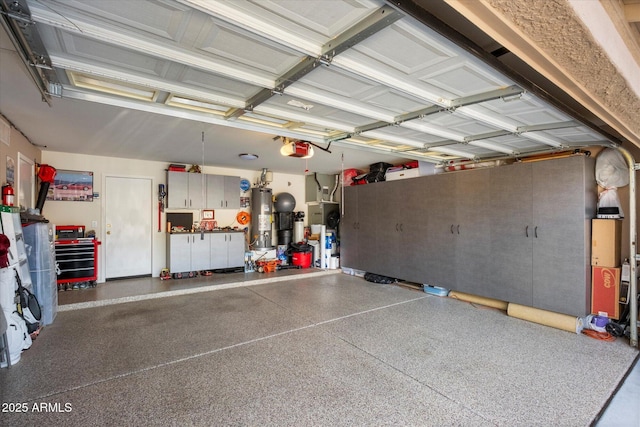 garage with gas water heater and a garage door opener