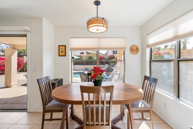 dining area featuring plenty of natural light and light tile patterned floors