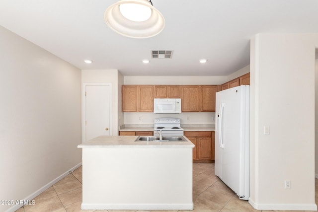 kitchen featuring white appliances, light tile patterned floors, visible vents, an island with sink, and a sink