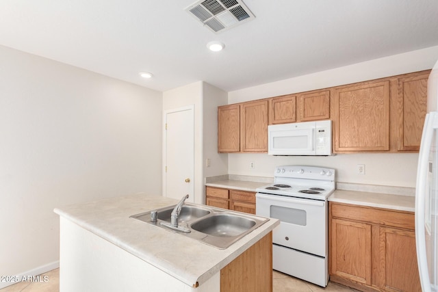 kitchen with white appliances, visible vents, light tile patterned flooring, a sink, and light countertops