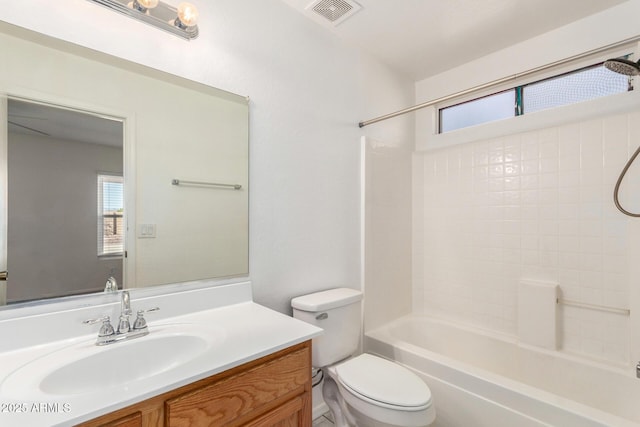 full bath with vanity, toilet, a healthy amount of sunlight, and visible vents