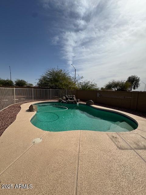 view of swimming pool featuring a patio area, a fenced in pool, and a fenced backyard