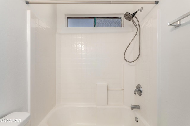 bathroom with tub / shower combination and toilet