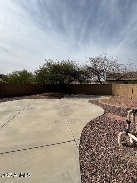 view of yard featuring a patio area and a fenced backyard