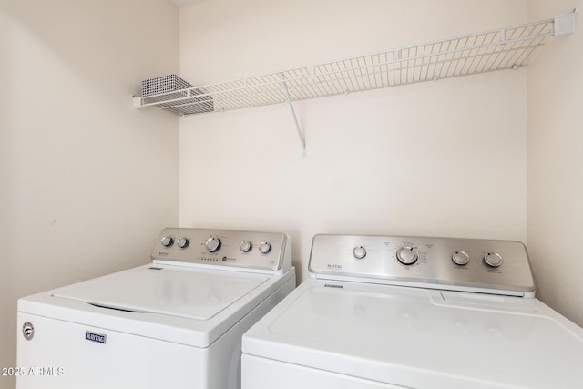 washroom with washer and clothes dryer and laundry area