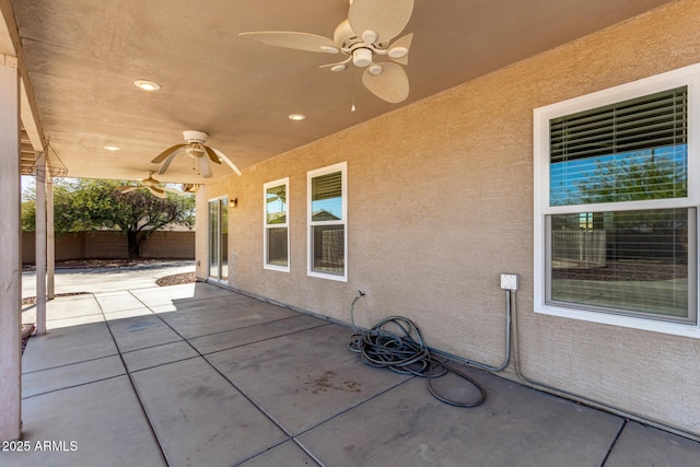 view of patio / terrace with ceiling fan and fence