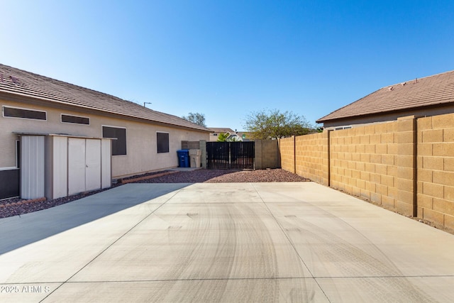 view of patio / terrace featuring fence and a gate
