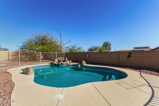 view of swimming pool with a fenced in pool, a patio, and a fenced backyard
