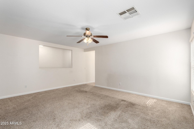 spare room featuring visible vents, carpet floors, baseboards, and a ceiling fan