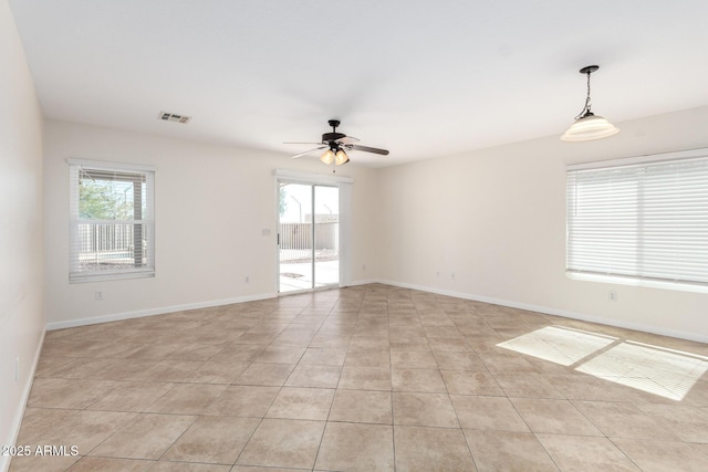 unfurnished room featuring light tile patterned floors, visible vents, baseboards, and a ceiling fan