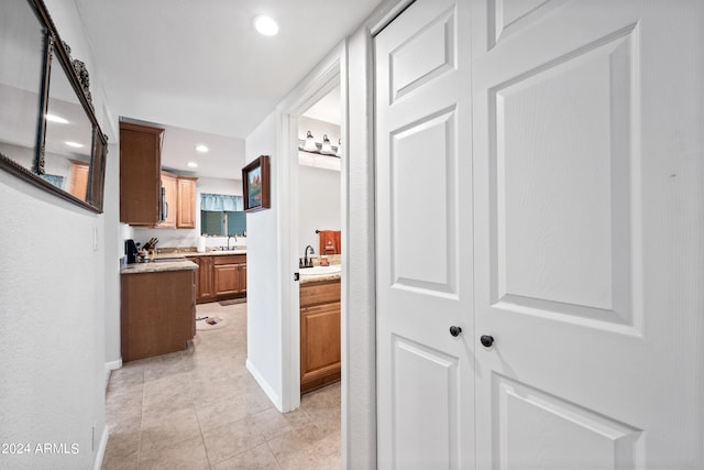 hallway with sink and light tile patterned floors