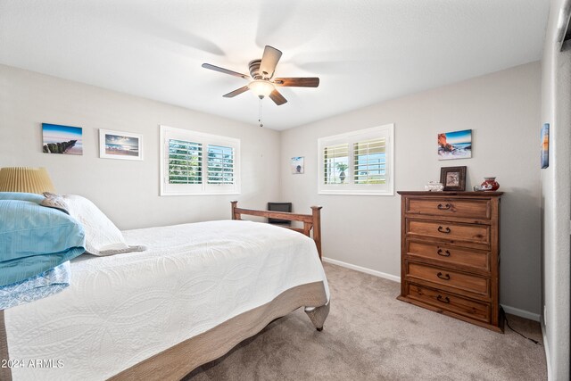 bedroom with light carpet and ceiling fan