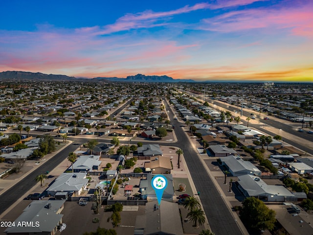 aerial view at dusk featuring a mountain view