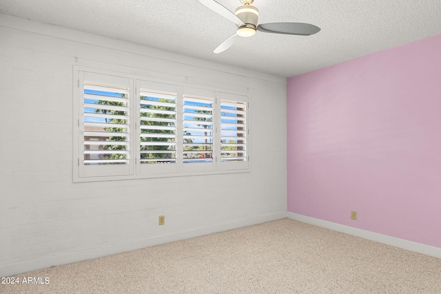 unfurnished room with ceiling fan, light carpet, and a textured ceiling