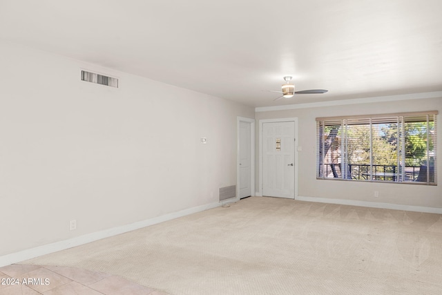 empty room with ceiling fan and light colored carpet