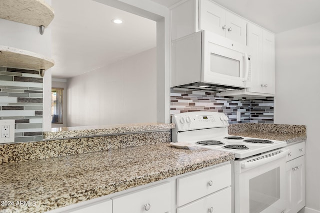 kitchen featuring white appliances, light stone countertops, white cabinetry, and tasteful backsplash