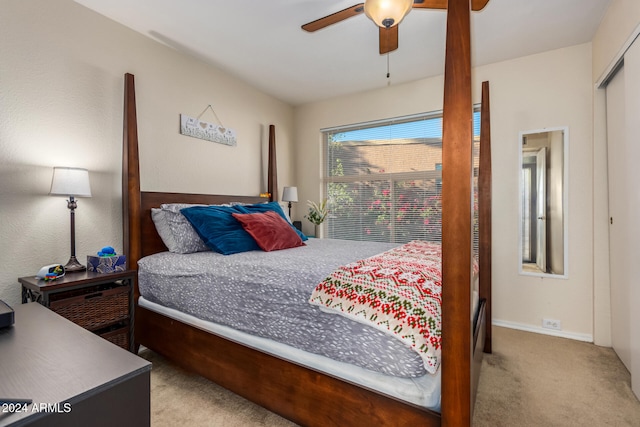 carpeted bedroom featuring ceiling fan and a closet