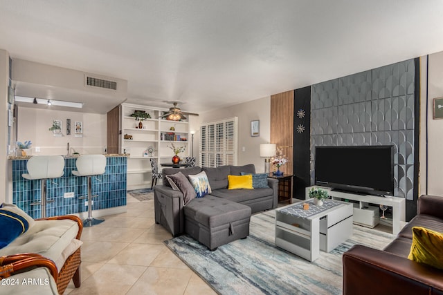 tiled living room with ceiling fan