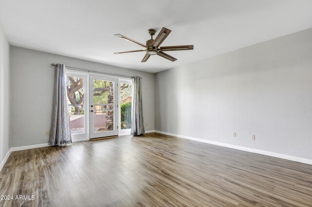 spare room with dark wood-type flooring and ceiling fan