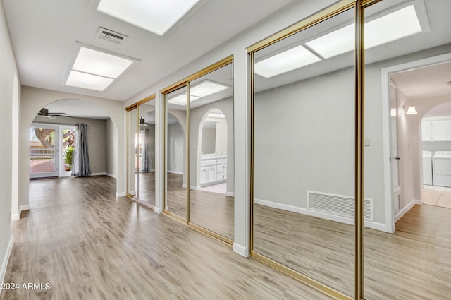 interior space featuring independent washer and dryer and light hardwood / wood-style flooring