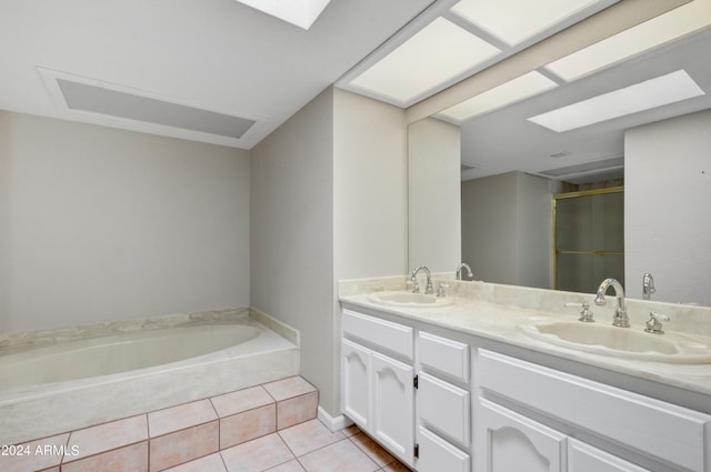 bathroom with vanity, a skylight, independent shower and bath, and tile patterned floors