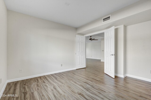 spare room with hardwood / wood-style flooring and ceiling fan