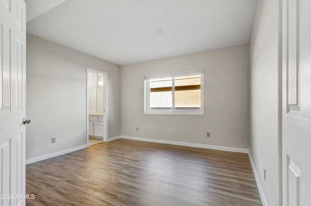 unfurnished room with dark wood-type flooring