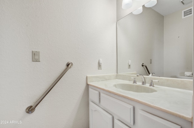 bathroom with toilet and vanity