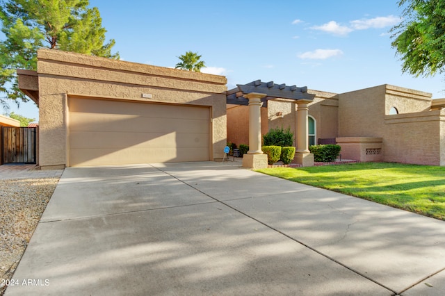 view of front of house featuring a garage and a front lawn