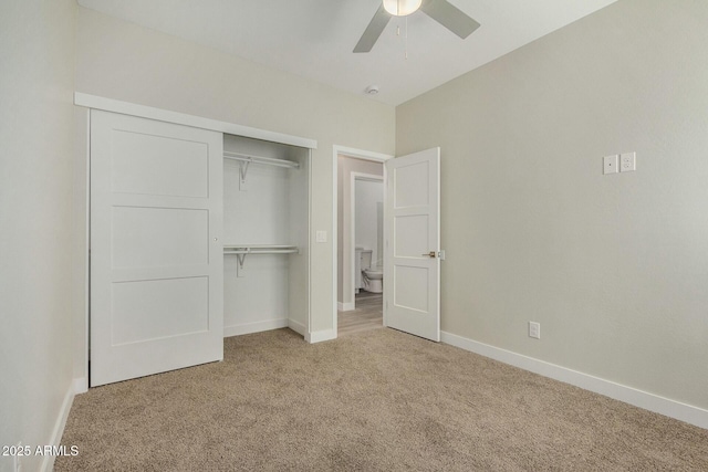 unfurnished bedroom with ceiling fan, light colored carpet, and a closet