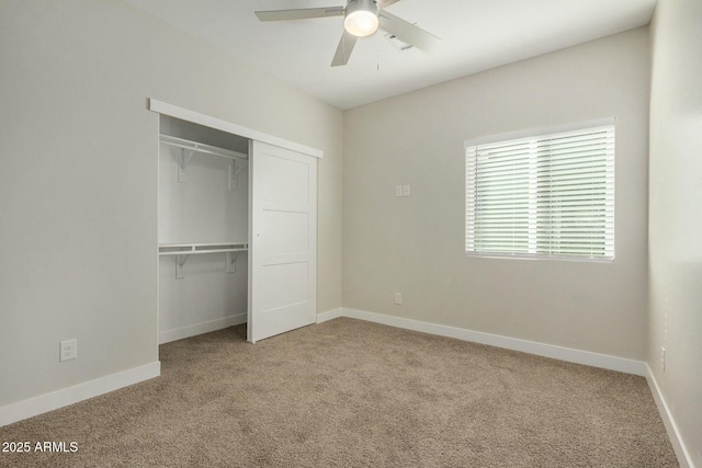 unfurnished bedroom featuring ceiling fan, a closet, and carpet floors