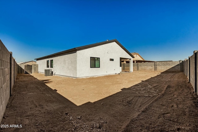 rear view of property with cooling unit