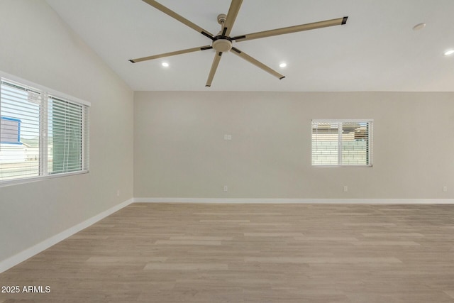 spare room with light hardwood / wood-style floors, ceiling fan, and lofted ceiling